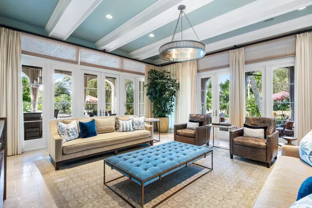 a bedroom with a bed a couch and a chandelier