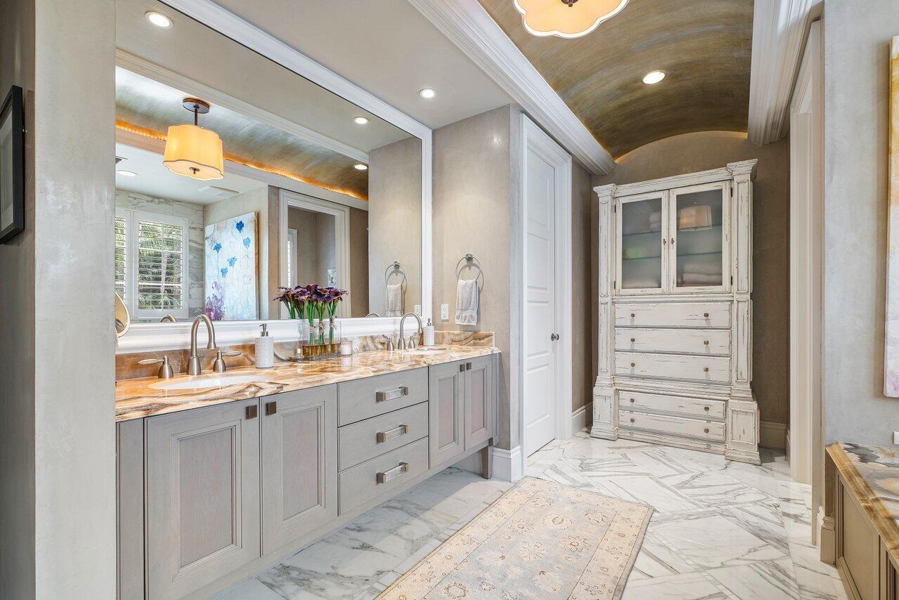 8 Driftwood Landing Road Gulf Stream, FL 33483 - Photo 53 of 67 a bathroom with a double vanity sink a vanity and a large mirror