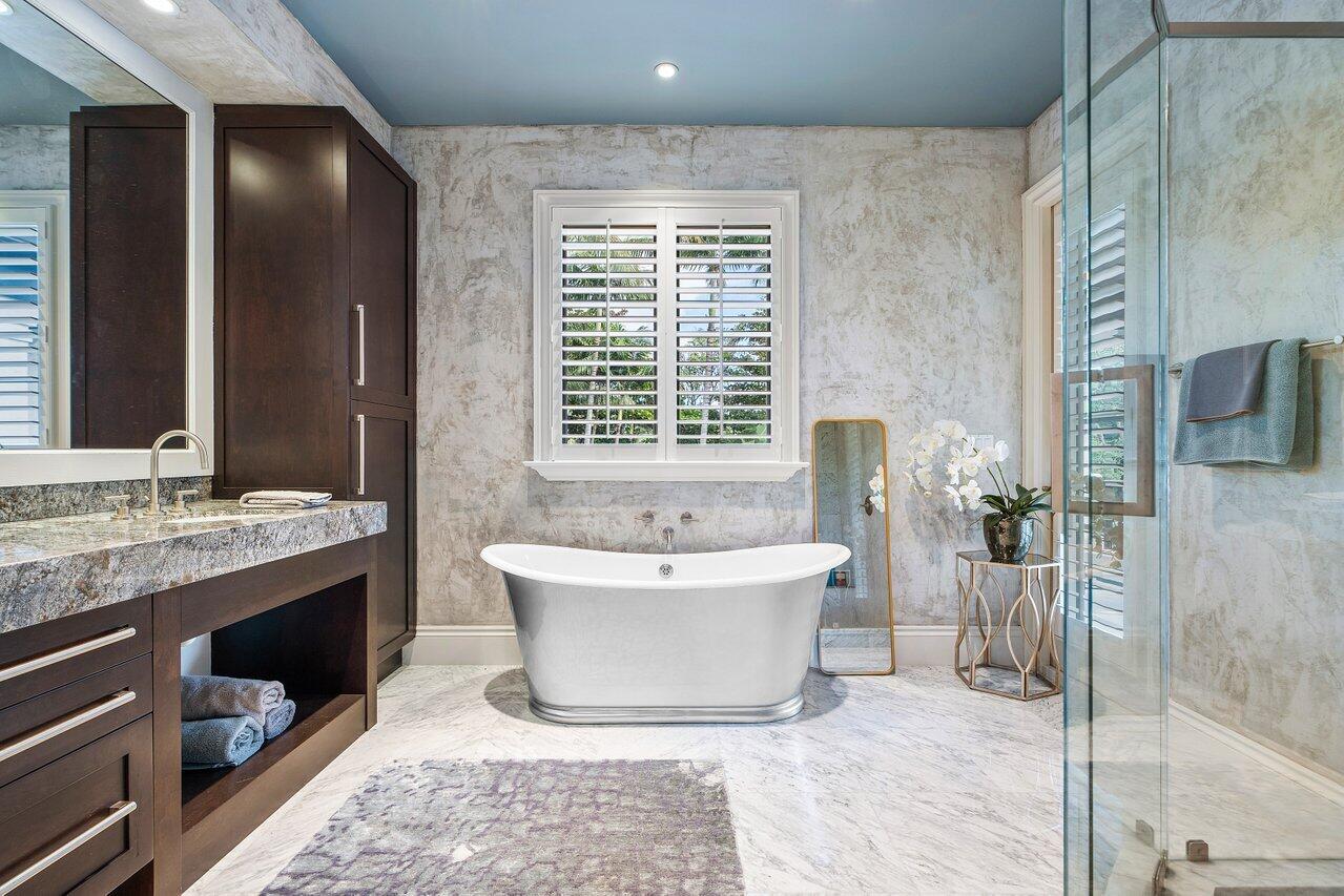 8 Driftwood Landing Road Gulf Stream, FL 33483 - Photo 57 of 67 a spacious bathroom with a tub sink and mirror