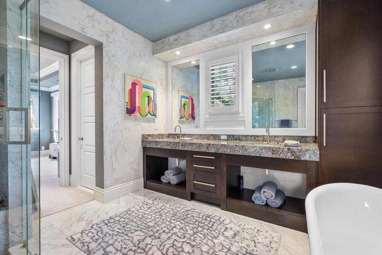 8 Driftwood Landing Road Gulf Stream, FL 33483 - Photo 58 of 67 a bathroom with a sink a vanity and a mirror