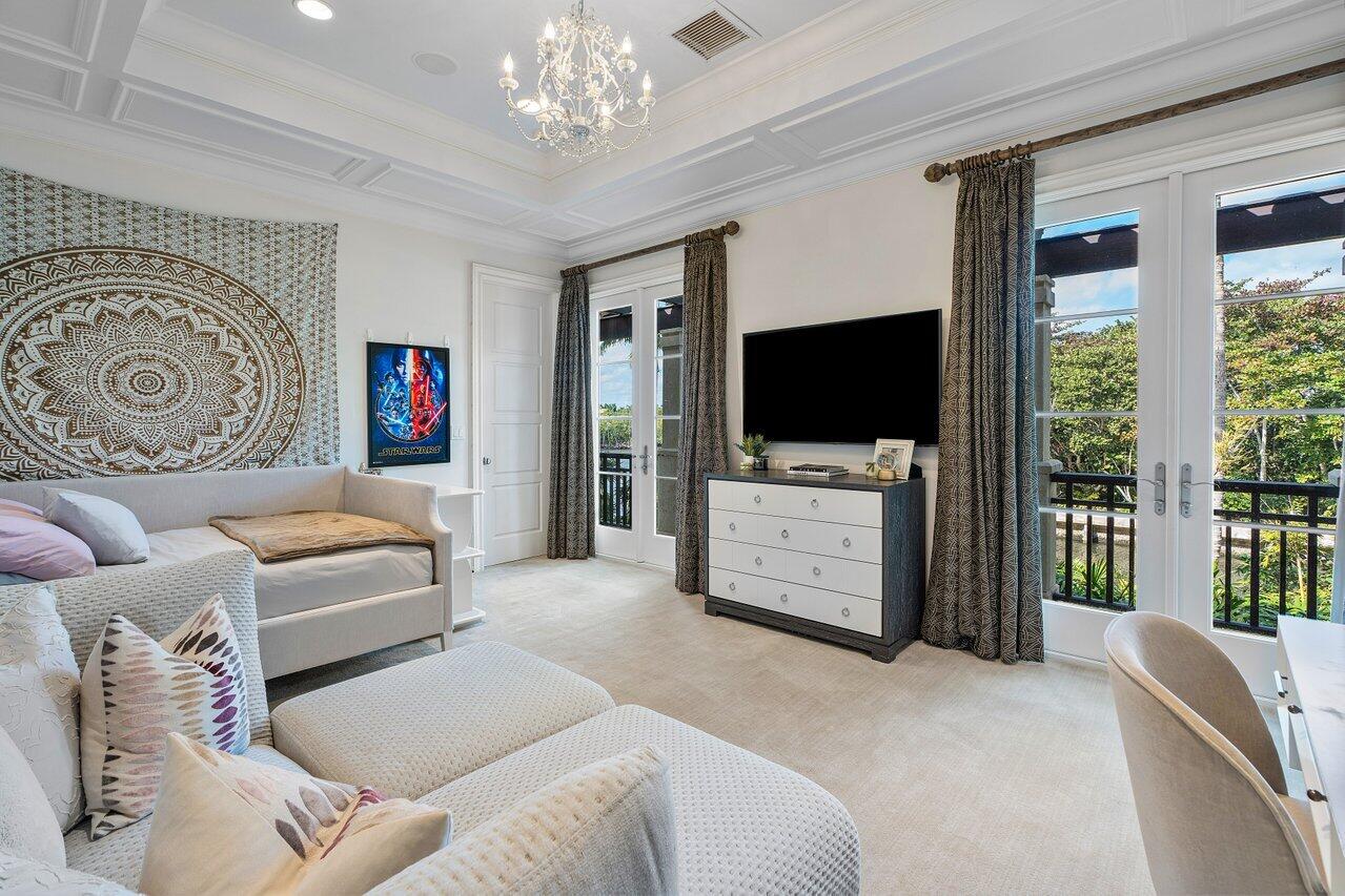 8 Driftwood Landing Road Gulf Stream, FL 33483 - Photo 59 of 67 a bedroom with furniture and flat screen tv