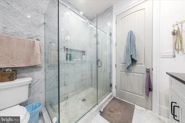 a bathroom with a shower a toilet and sink