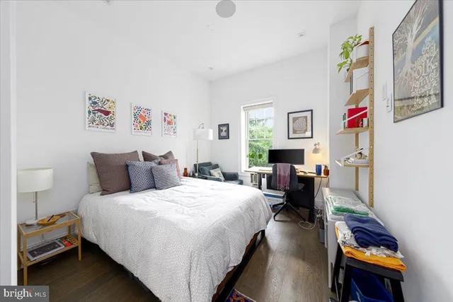 a bedroom with a bed and a desk