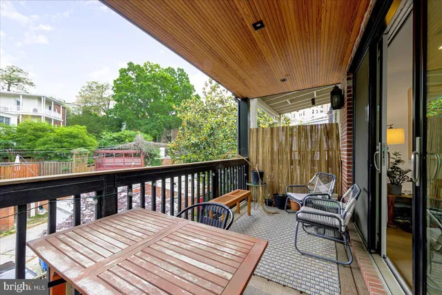 a view of a balcony with couch and wooden floor