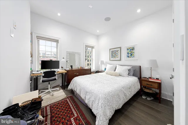 a bedroom with bed chair and window