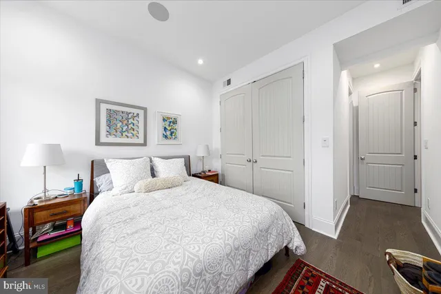 a bedroom with a bed and a lamp