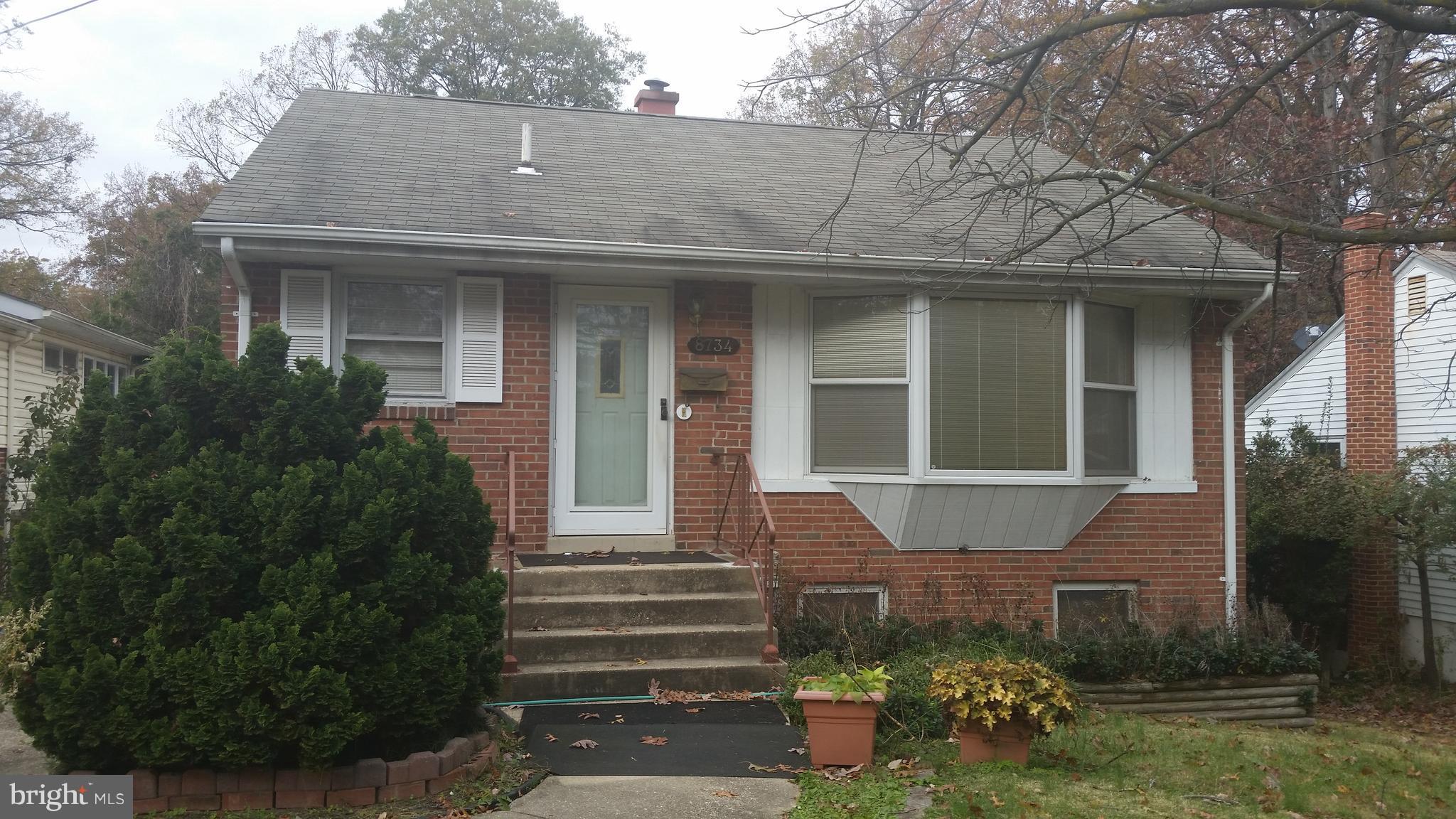 8734 Edmonston Road Berwyn Heights, MD 20740 - Photo 1 of 13 a front view of a house with a yard