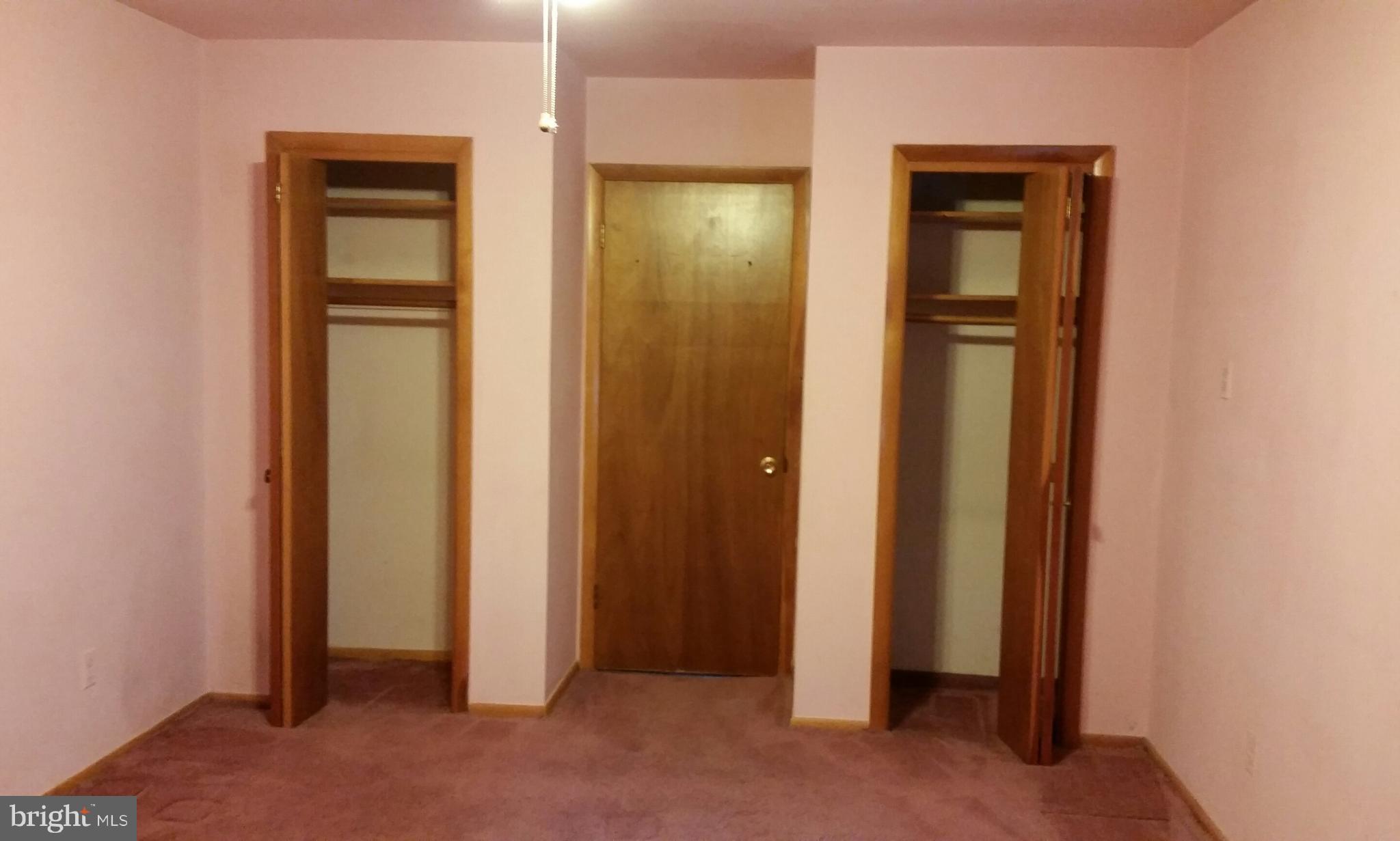 8734 Edmonston Road Berwyn Heights, MD 20740 - Photo 7 of 13 an empty room with closet and wooden floor