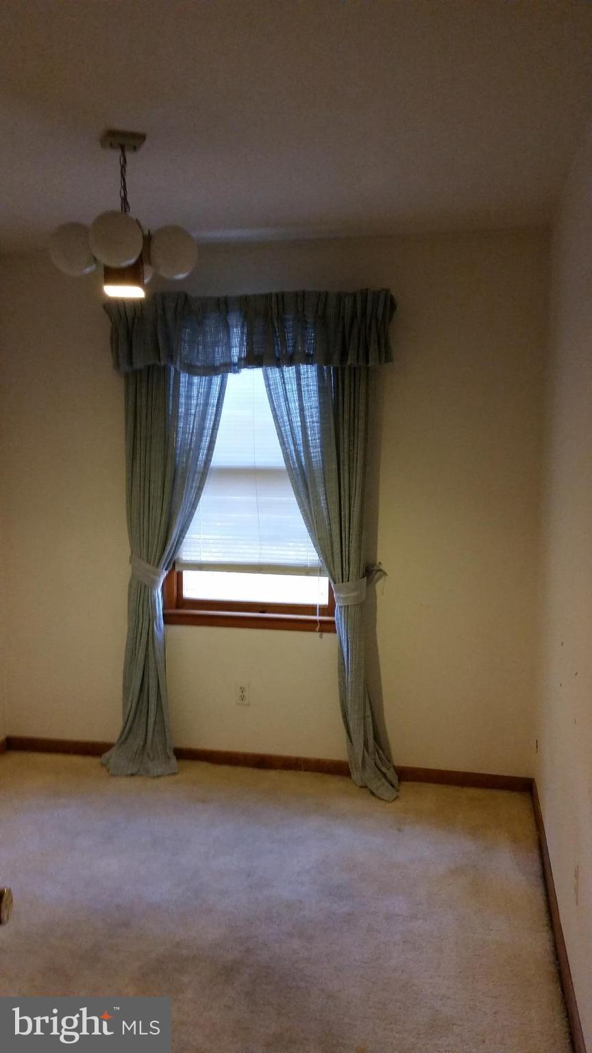 8734 Edmonston Road Berwyn Heights, MD 20740 - Photo 8 of 13 a view of room with a window and chandelier