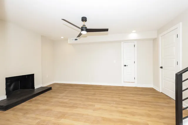 a view of a livingroom with an empty space and a ceiling fan