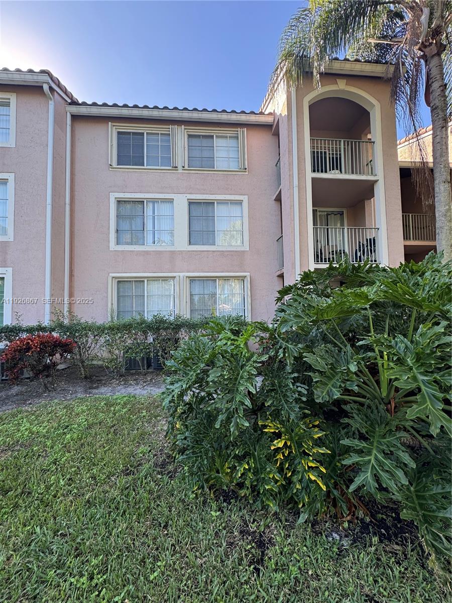 12124 St Andrews Place, Unit 206 Miramar, FL 33025 - Photo 14 of 20 a front view of a house with yard and green space