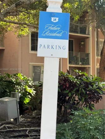 a view of a yard with cars on the road