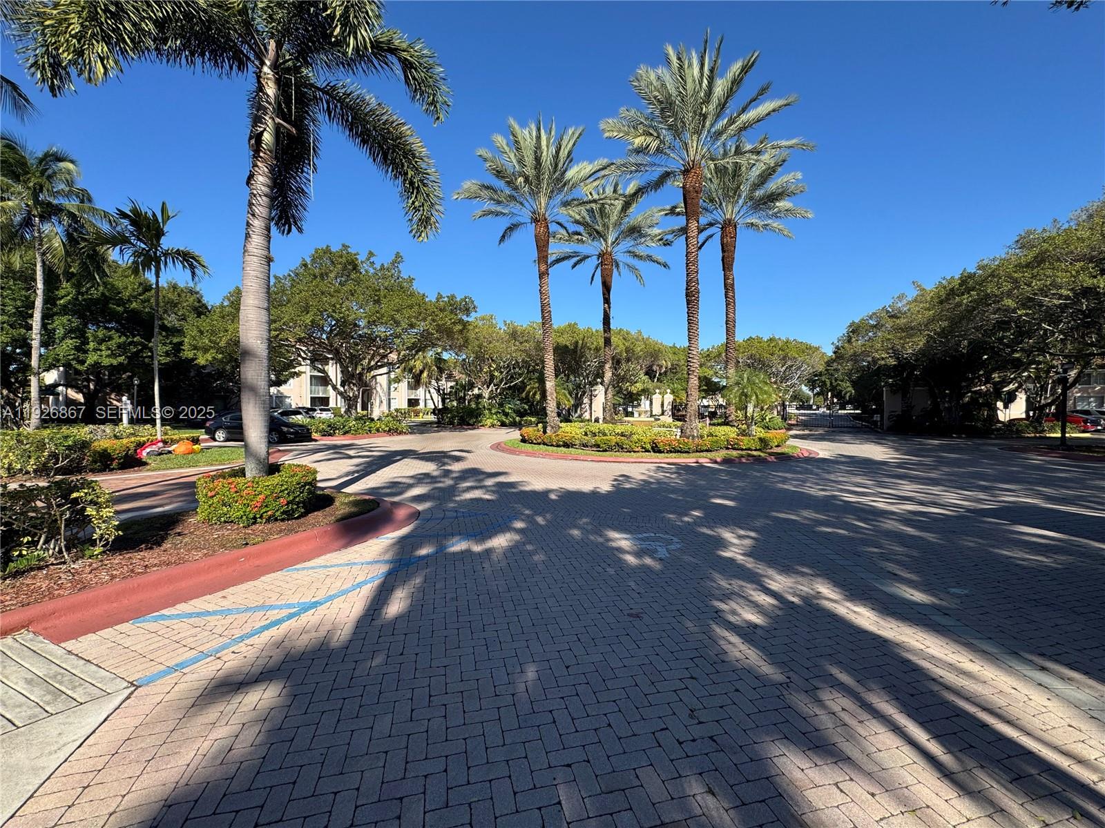 12124 St Andrews Place, Unit 206 Miramar, FL 33025 - Photo 18 of 20 a view of a yard with cars on the road