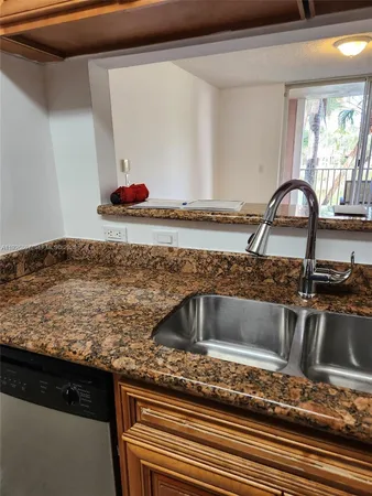 a kitchen with sink and window