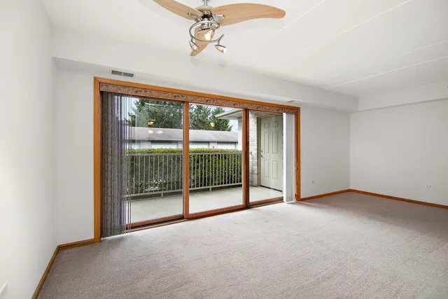 a view of empty room with sliding glass door