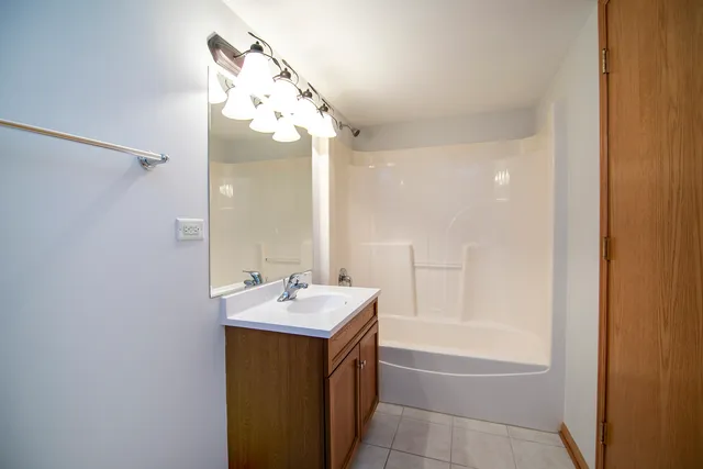 a bathroom with a bathtub a sink and a mirror