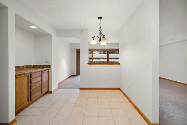 a hallway with window and flowerpot