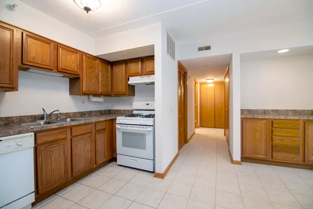a kitchen with stainless steel appliances granite countertop a stove and a sink