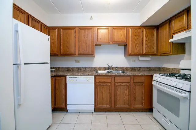 a kitchen with a stove top oven sink and cabinets