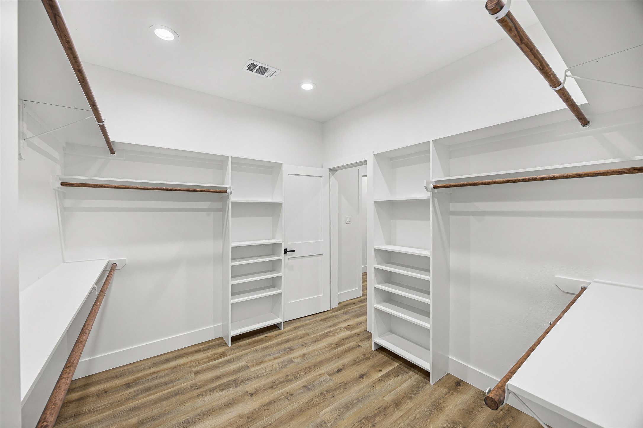 1807 Waco Street Dayton, TX 77535 - Photo 18 of 26 Spacious walk-in closet with double hanging rods and ample storage.