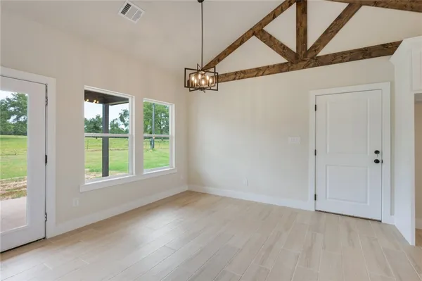 a kitchen with stainless steel appliances kitchen island a sink cabinets and wooden floor