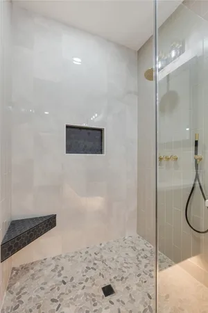 a bathroom with a double vanity sink mirror and bathtub