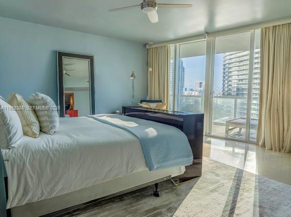 450 Alton Road, Unit 1202 Miami Beach, FL 33139 - Photo 63 of 68 a bedroom with a large bed and a chandelier