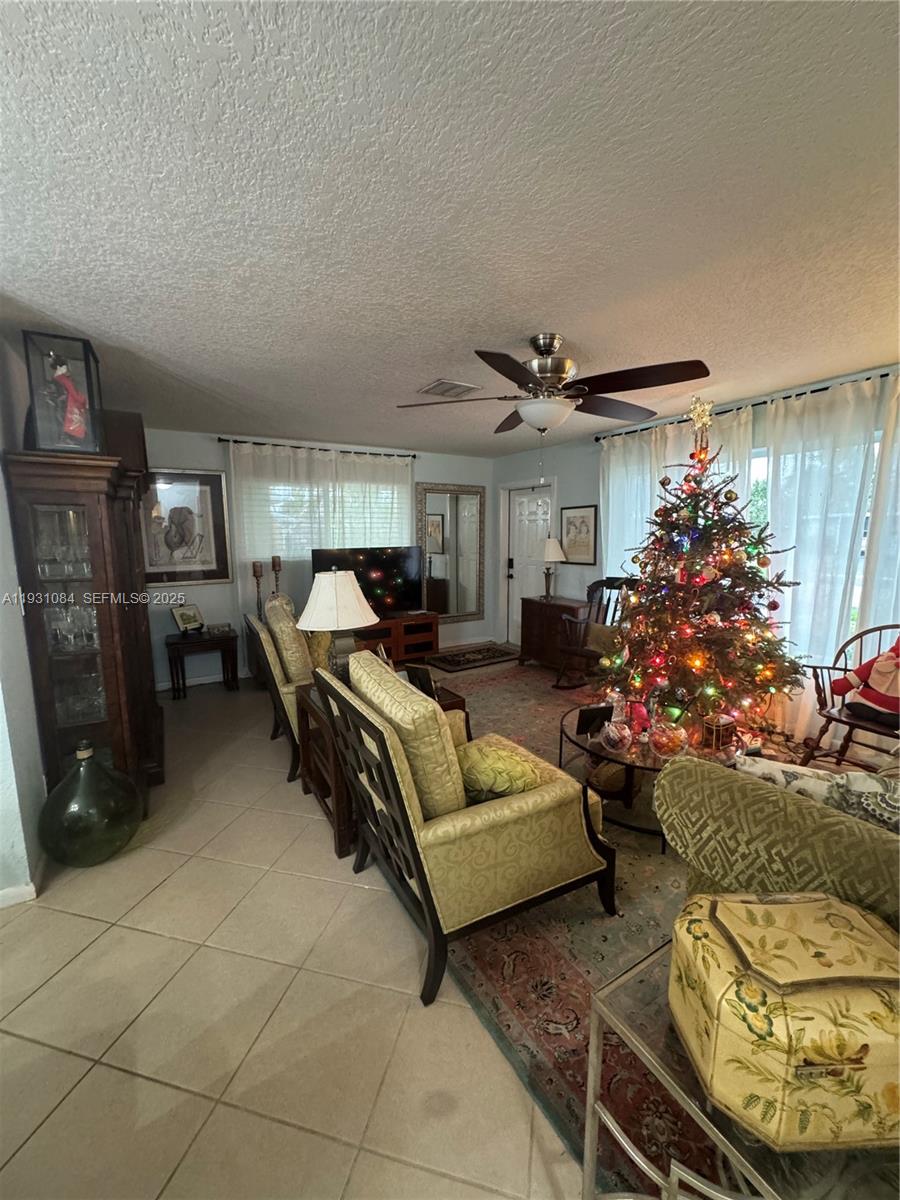 918 Southeast 16th Street, Unit 918 Deerfield Beach, FL 33441 - Photo 3 of 20 a living room with furniture and a potted plant