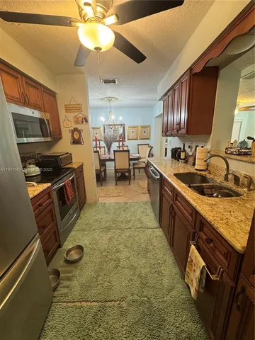 a kitchen with sink cabinets and window