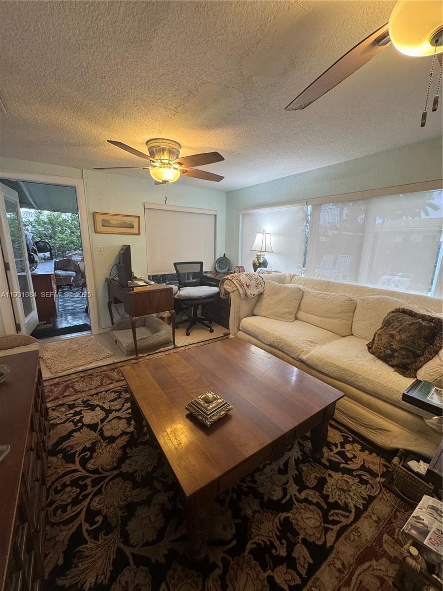 918 Southeast 16th Street, Unit 918 Deerfield Beach, FL 33441 - Photo 9 of 20 a living room with furniture and a rug