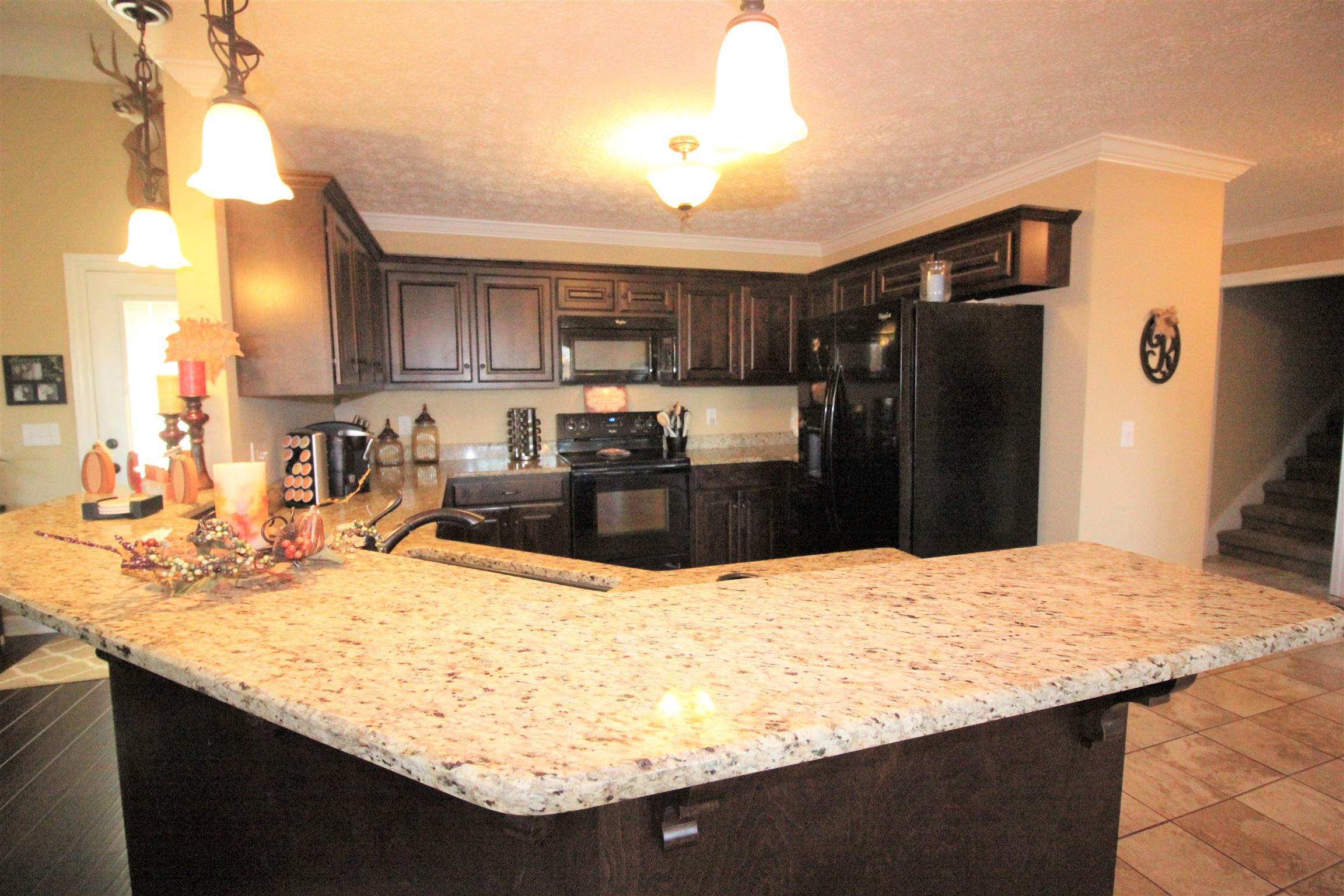 304 Williams Road Manchester, TN 37355 - Photo 6 of 20 a kitchen with kitchen island sink refrigerator and cabinets