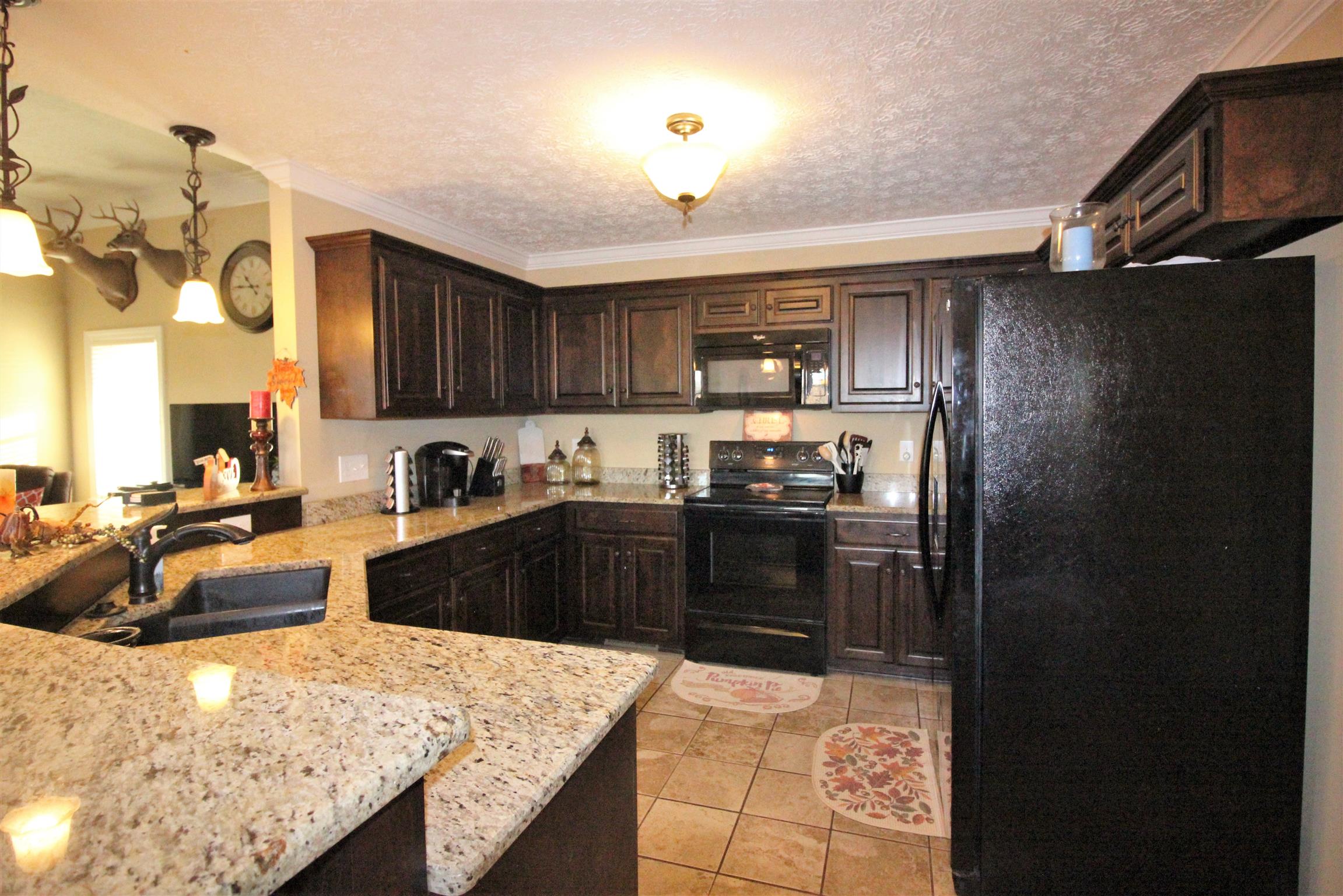 304 Williams Road Manchester, TN 37355 - Photo 7 of 20 a kitchen with granite countertop a refrigerator stove and sink