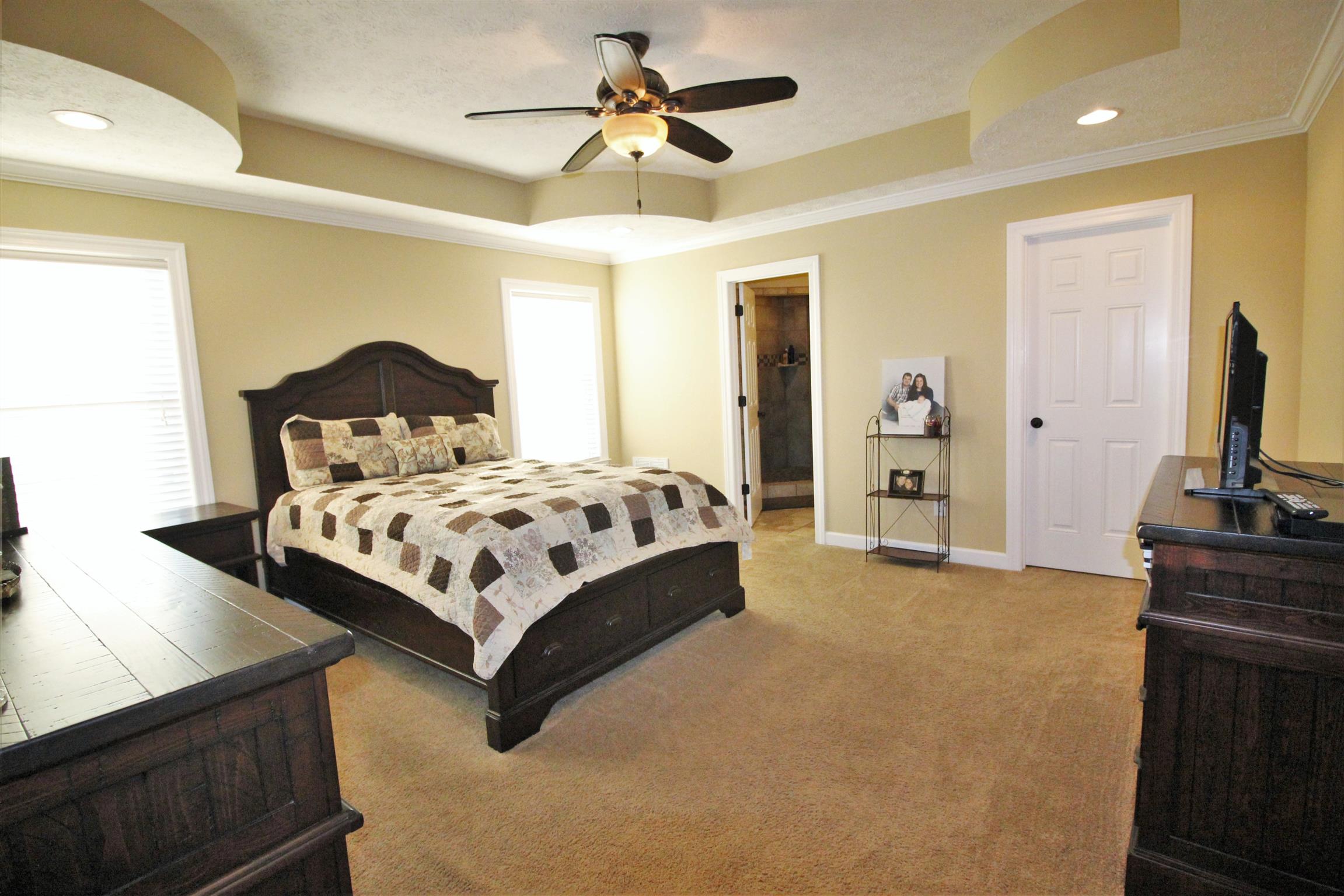 304 Williams Road Manchester, TN 37355 - Photo 9 of 20 a bedroom with a bed flat screen tv and a chandelier