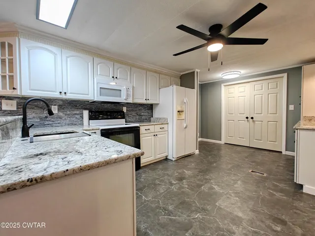 a kitchen that has a cabinets a sink and appliances