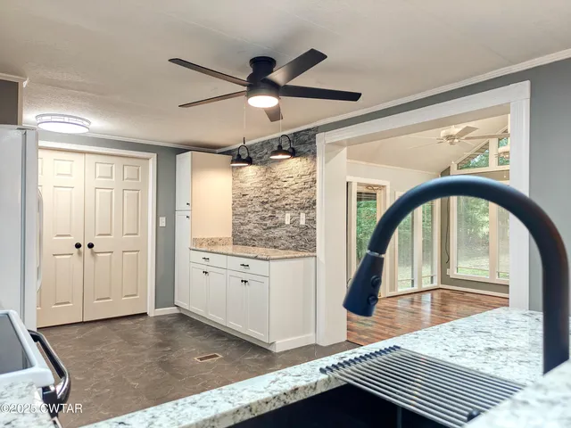 a living room with granite countertop furniture and a wooden floor