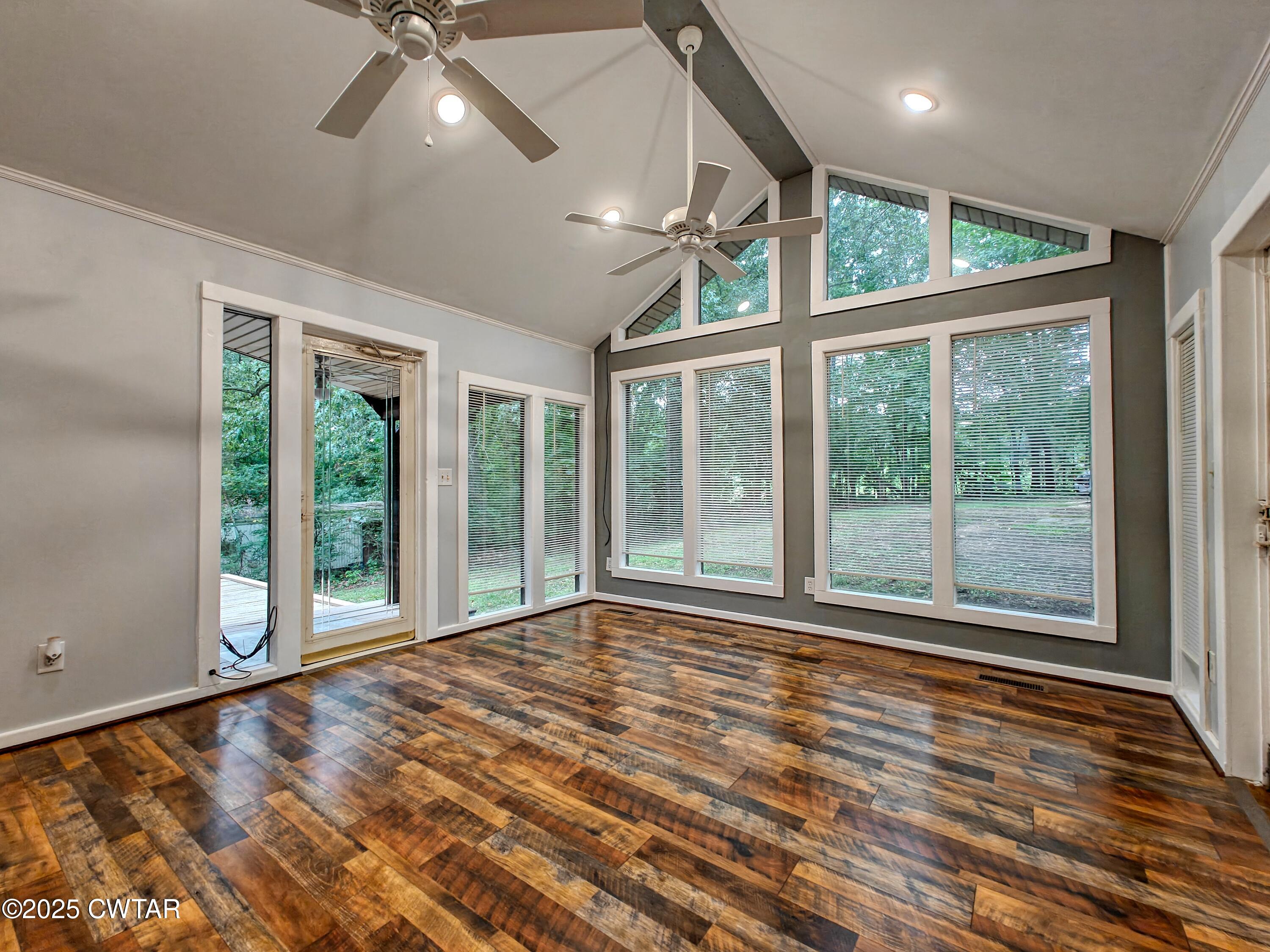 260 Cotham Drive Huntingdon, TN 38344 - Photo 17 of 29 a view of an empty room with a window and wooden floor