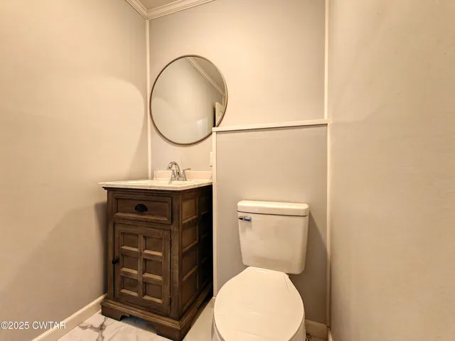 a bathroom with a toilet a sink and a mirror