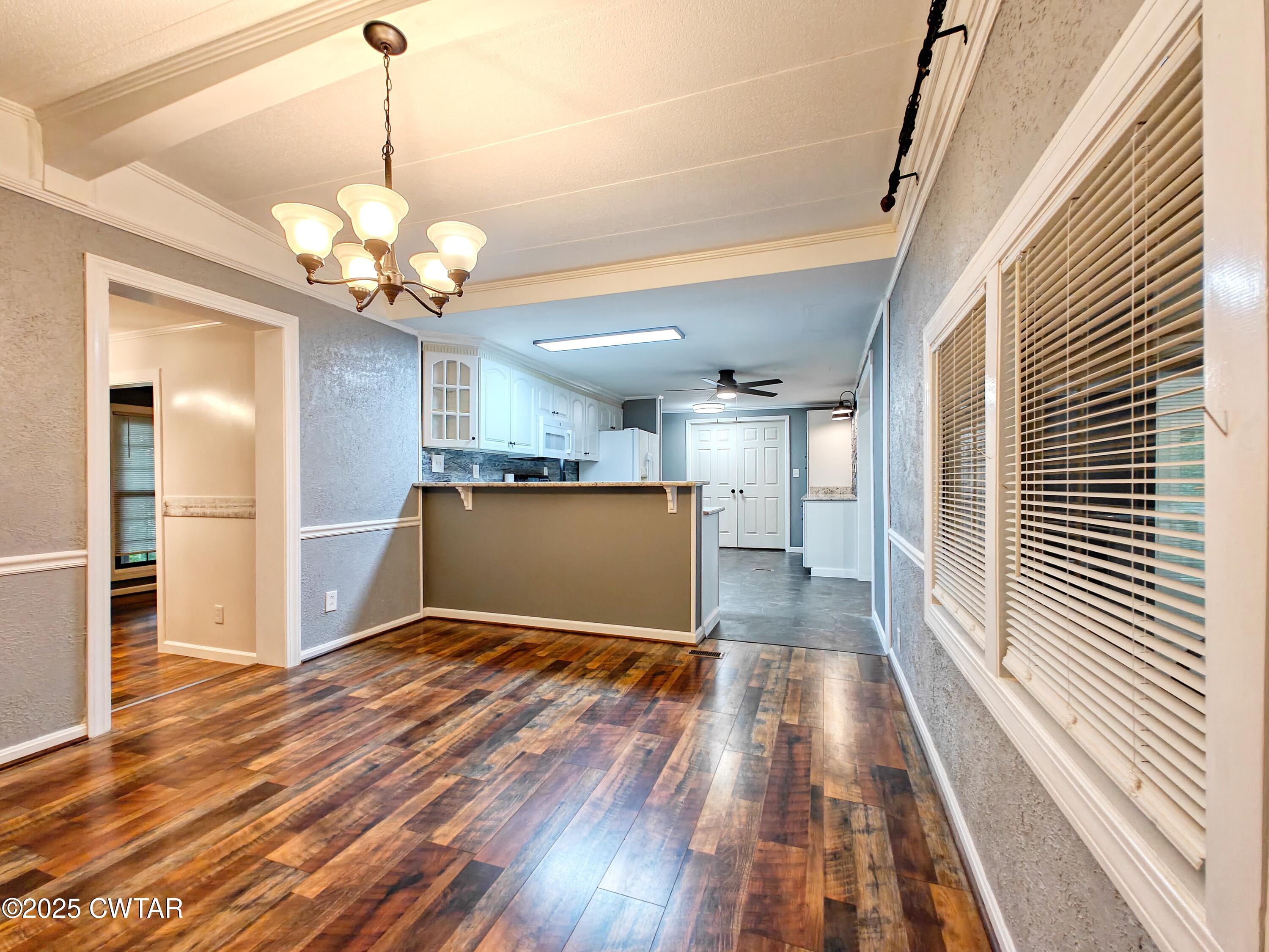 260 Cotham Drive Huntingdon, TN 38344 - Photo 20 of 29 a view of a livingroom with a furniture wooden floor and chandelier