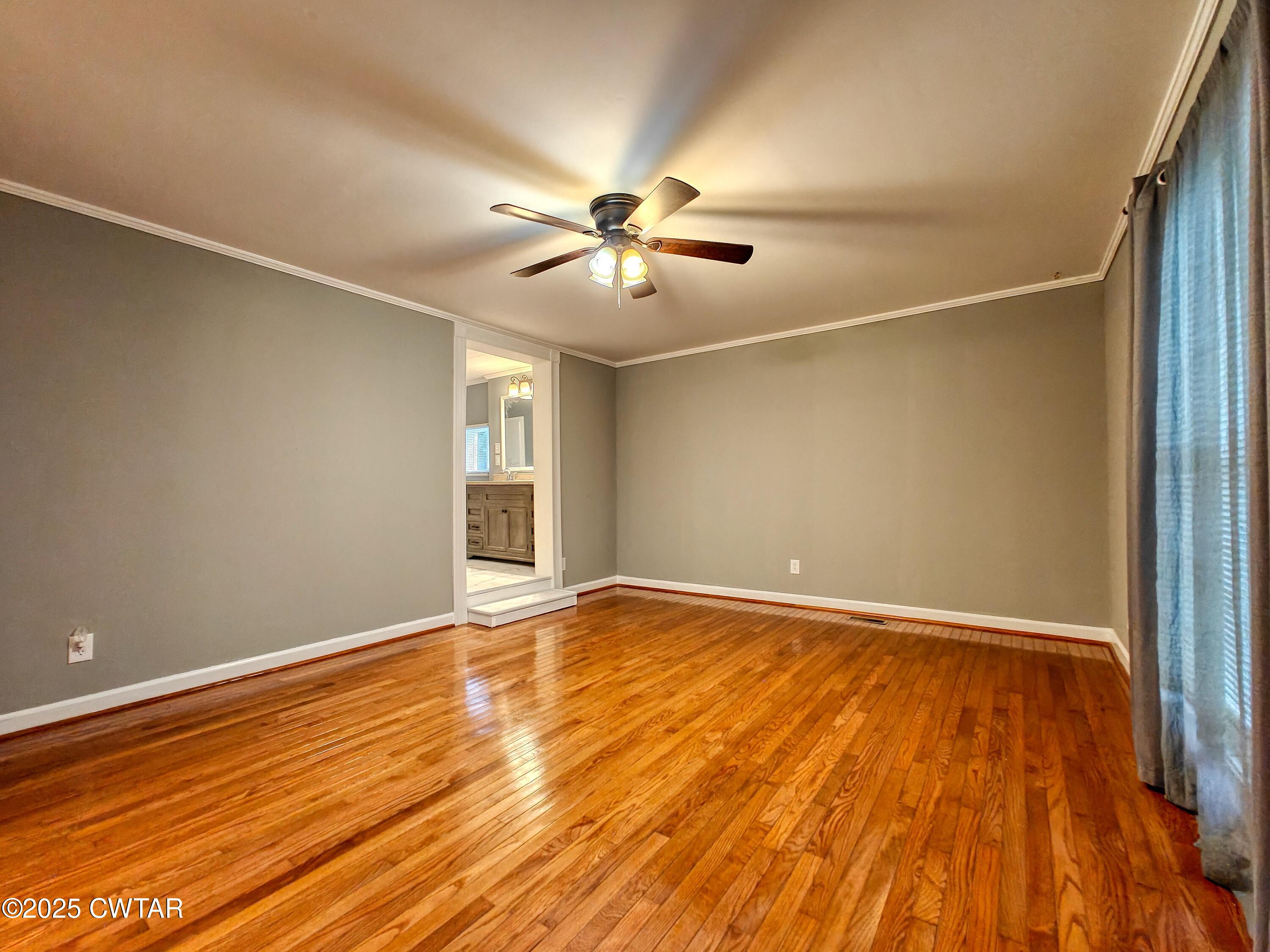 260 Cotham Drive Huntingdon, TN 38344 - Photo 21 of 29 wooden floor in an empty room with a window