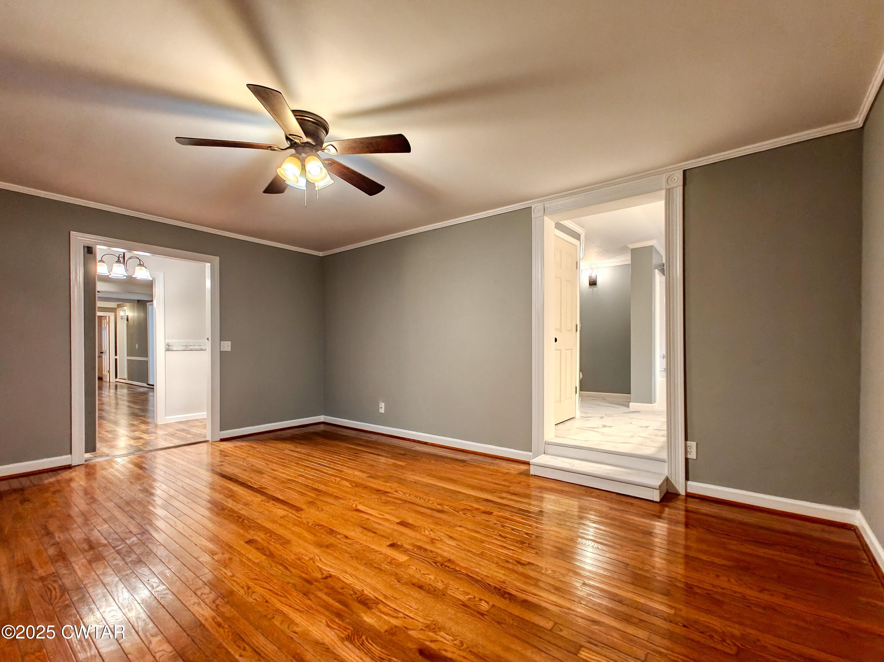 260 Cotham Drive Huntingdon, TN 38344 - Photo 22 of 29 a view of an empty room with window and wooden floor