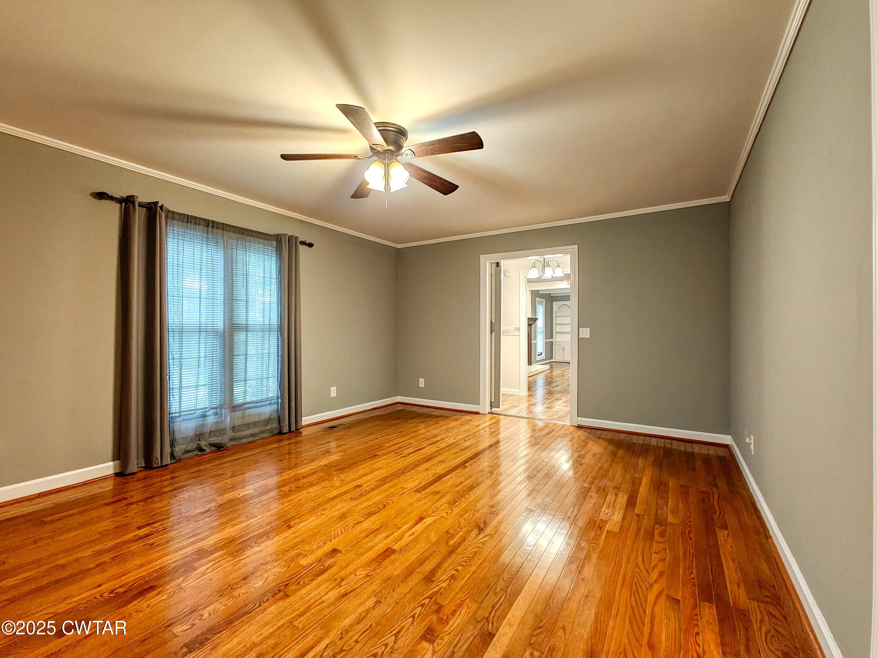 260 Cotham Drive Huntingdon, TN 38344 - Photo 23 of 29 a view of an empty room with wooden floor and a window