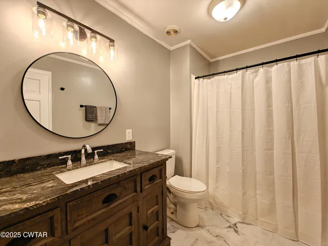 a bathroom with a granite countertop sink a mirror and a shower curtain