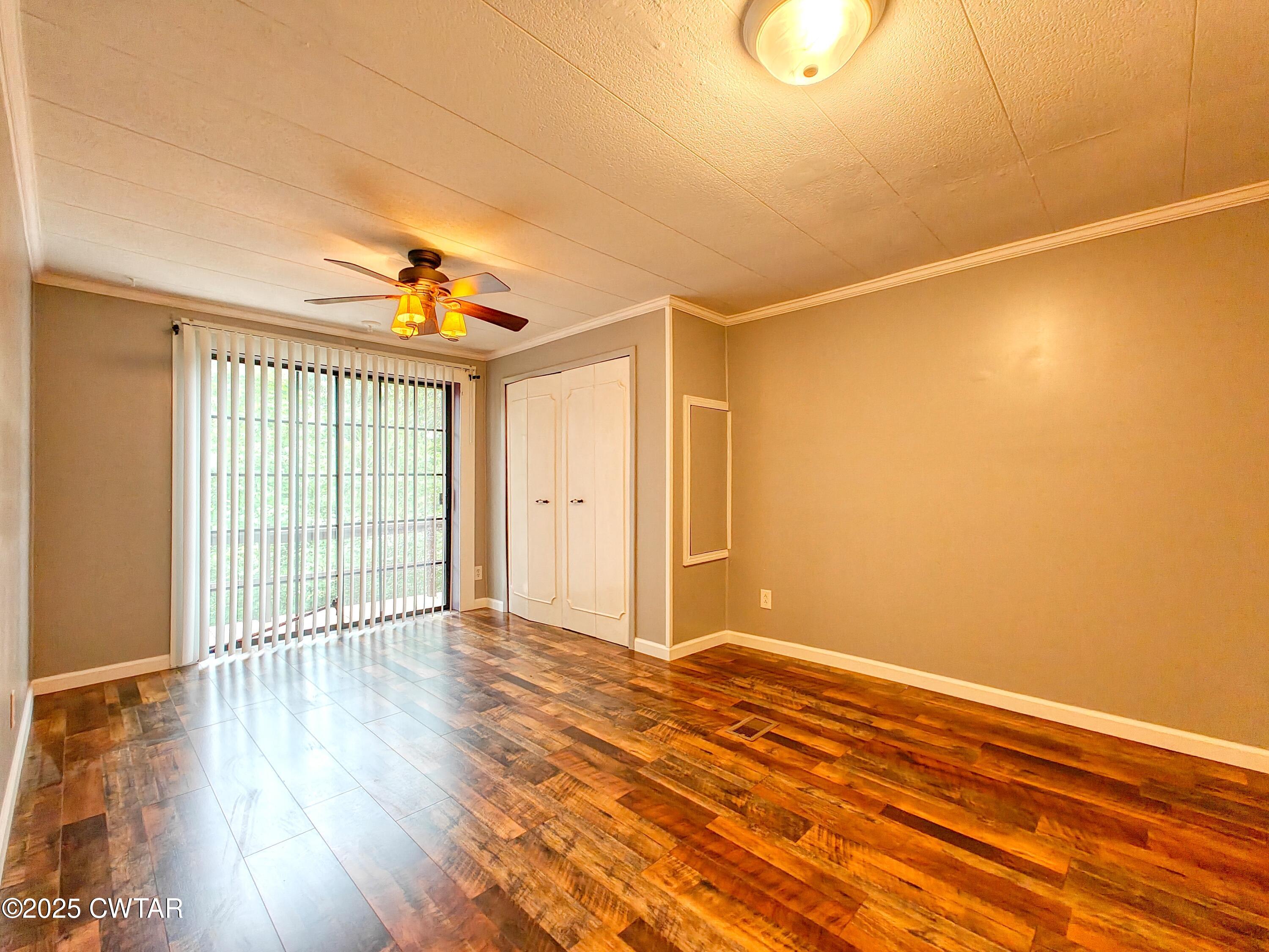 260 Cotham Drive Huntingdon, TN 38344 - Photo 28 of 29 a view of an empty room with wooden floor and a window
