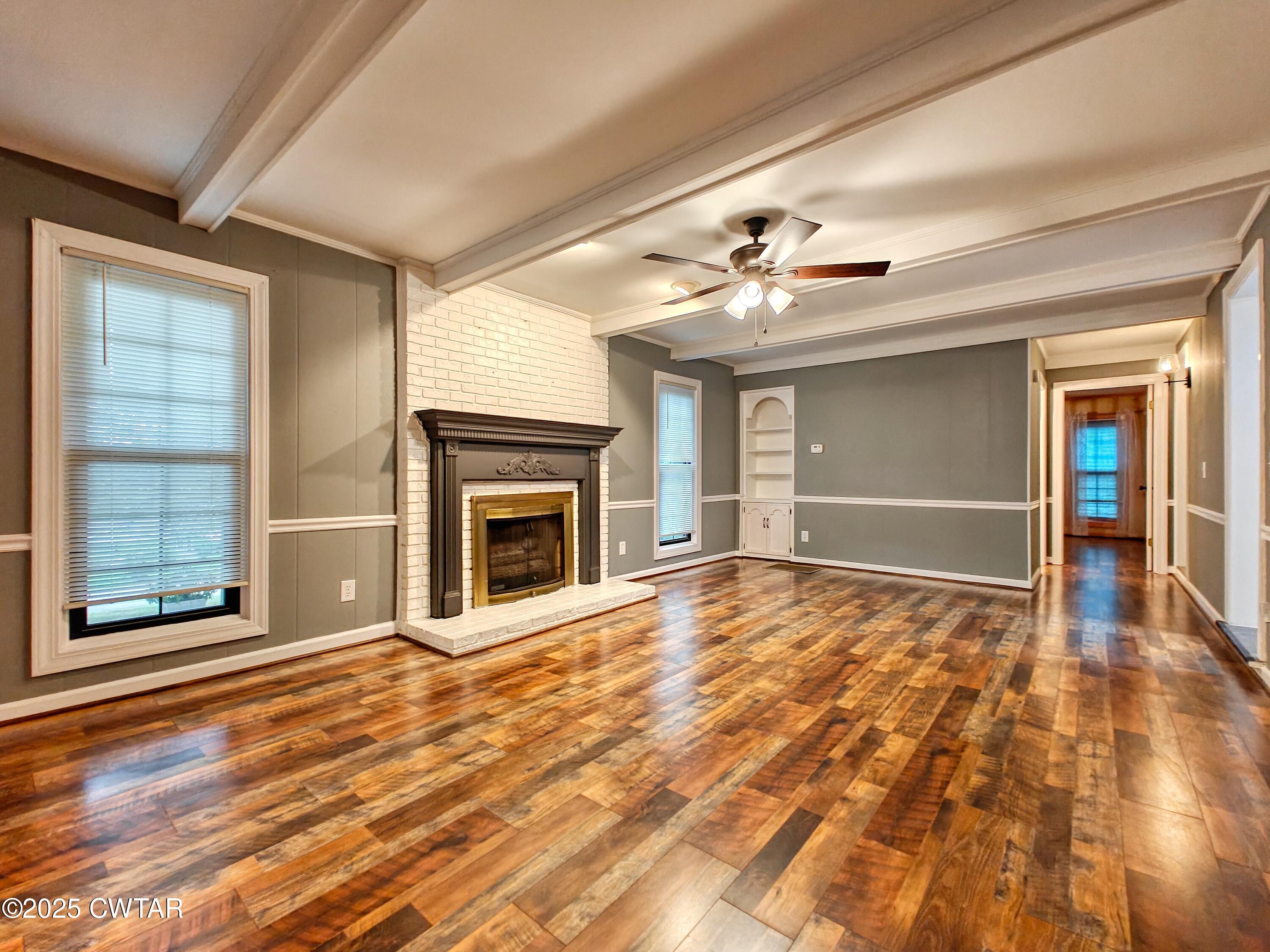 260 Cotham Drive Huntingdon, TN 38344 - Photo 9 of 29 a view of an empty room with a fireplace and a window