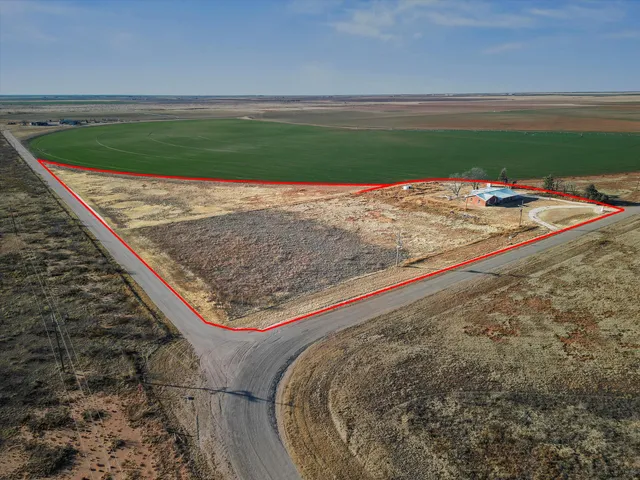a view of a kitchen with wooden floor and electronic appliances