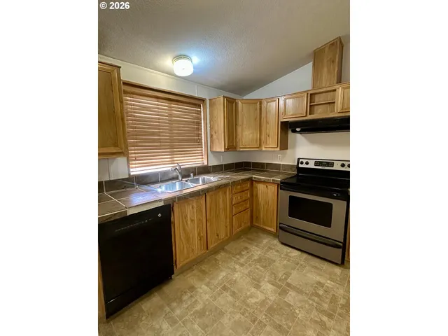a kitchen with stainless steel appliances granite countertop a stove and a sink