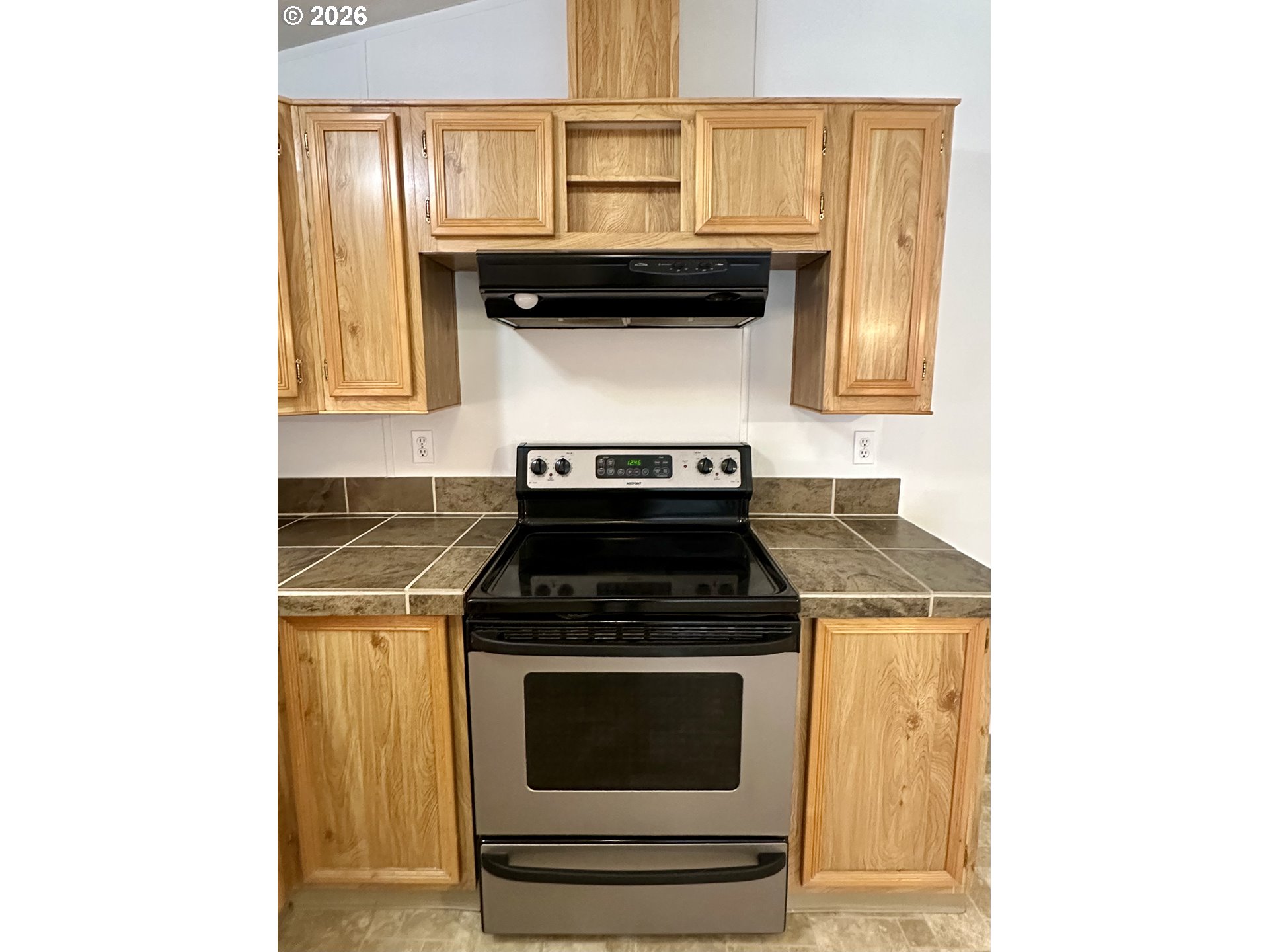 2009 Lewis River Road, Unit 17 Woodland, WA 98674 - Photo 19 of 32 a stove top oven sitting inside of a kitchen
