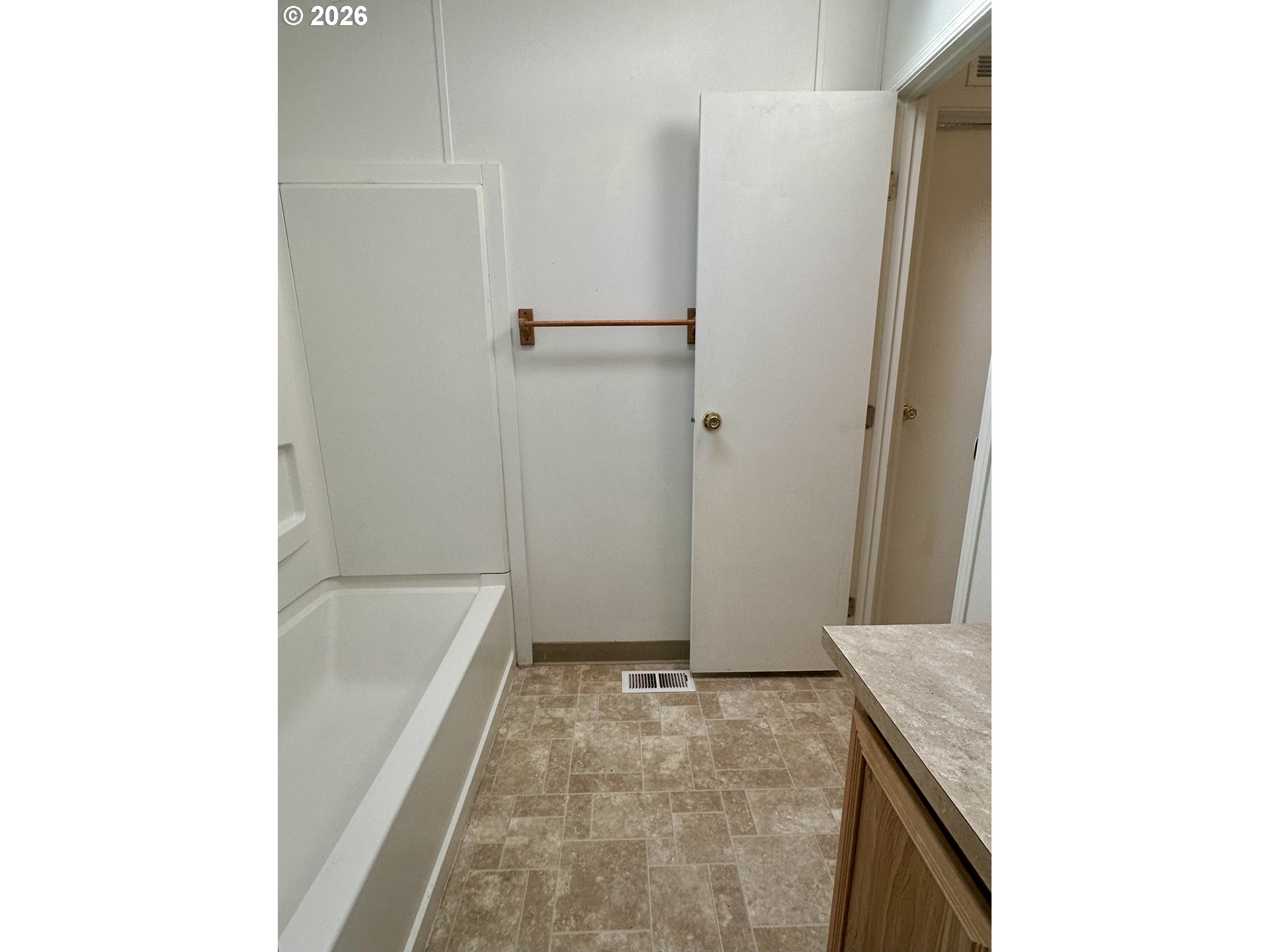 2009 Lewis River Road, Unit 17 Woodland, WA 98674 - Photo 24 of 32 a bathroom with a granite countertop sink a mirror and a bathtub
