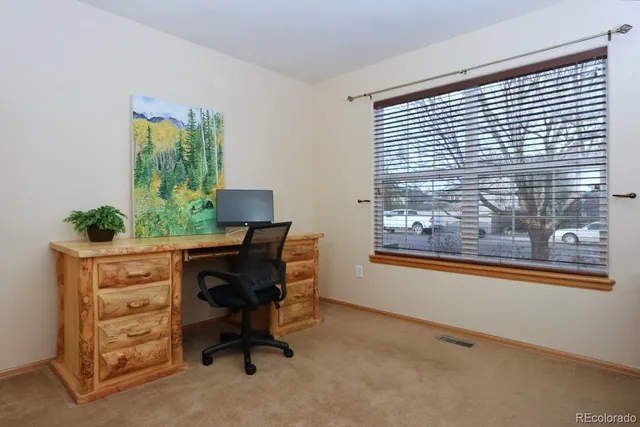 a workspace with furniture and a window