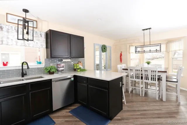 a kitchen with sink and view living room